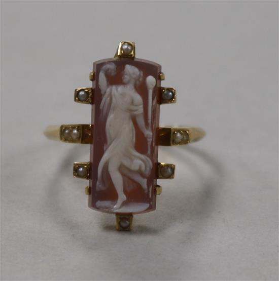 An Edwardian yellow metal, hardstone cameo and seed pearl ring with seed pearl set shoulders, size N.